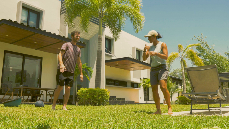 Two people outdoors on the clinic's garden lawn