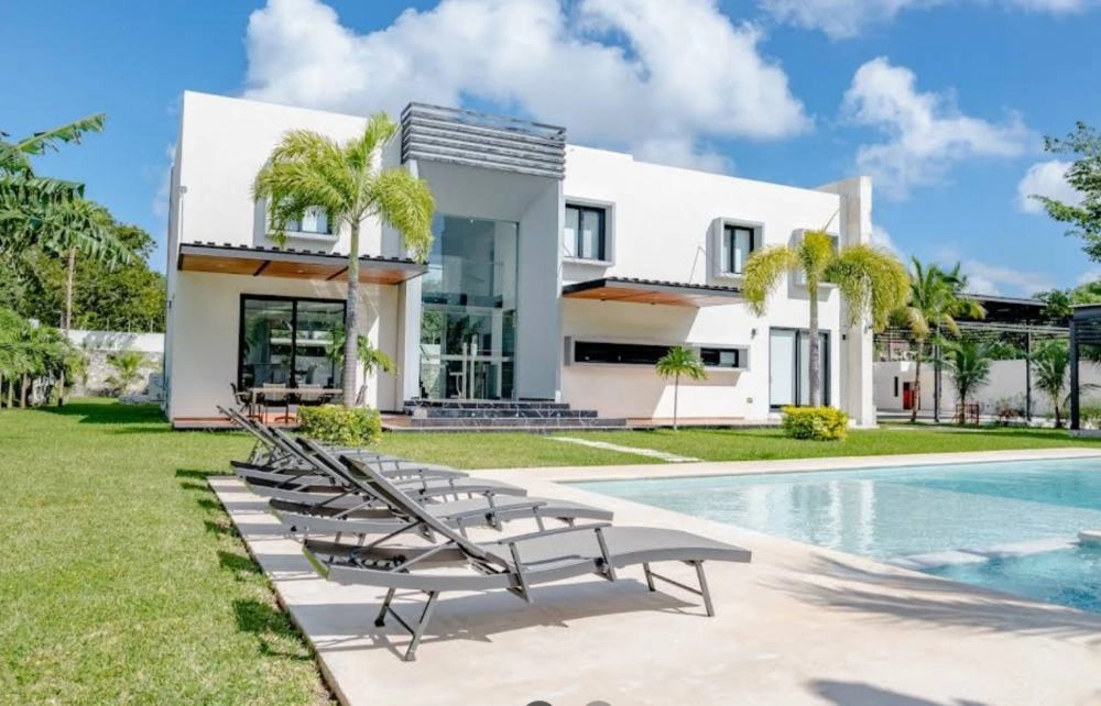 Poolside loungers and the Care Center exterior at Transcend Clinic