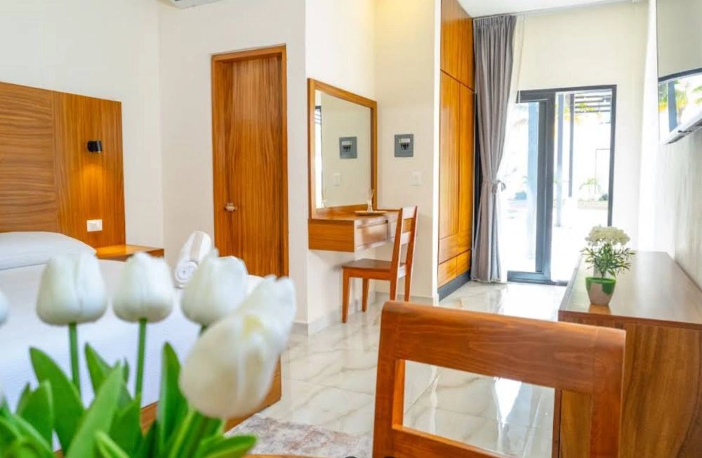 A private room at Transcend Clinic with a bed, desk and garden-facing doorway