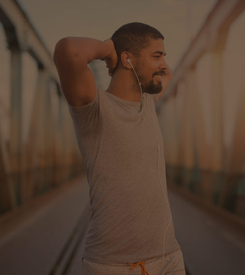 A man standing confidently with a hopeful smile, representing triumph over Adderall addiction. His expression reflects strength and renewal, symbolizing the journey to recovery and a brighter future.