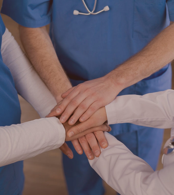 Group of individuals holding hands, symbolizing unity, support, and collective healing.