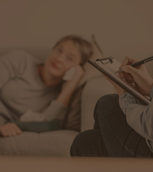 A woman lying on a bed, engaged in a compassionate and supportive conversation with her therapist. The scene captures a moment of vulnerability and trust as she seeks guidance on overcoming her challenges with Oxycodone and Oxycontin addiction